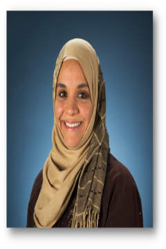 Smiling woman in beige scarf and brown top