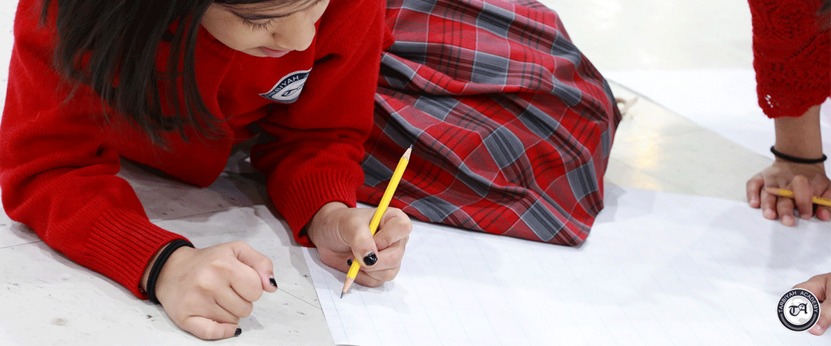 Image of girl in plaid outfit writing with a pencil