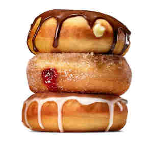 three donuts stacked - chocolate, jam filled, and glazed