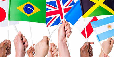 Children's hands holding flags from around the world