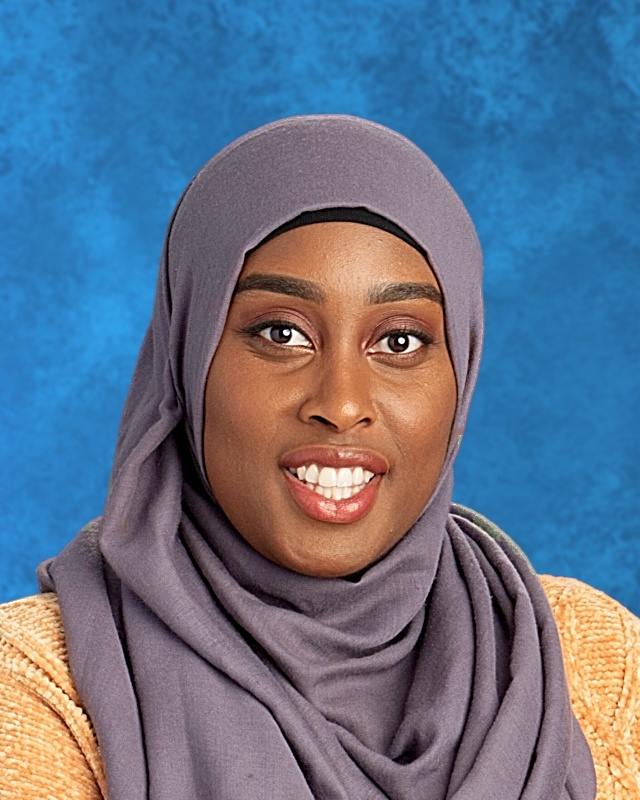 Photo of smiling woman with gray hijaab