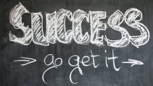 SUCCESS - go get it written in white chalk on black chalkboard