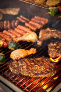 [ID: chicken drumsticks, grilled steak, and hot dogs on a grill]